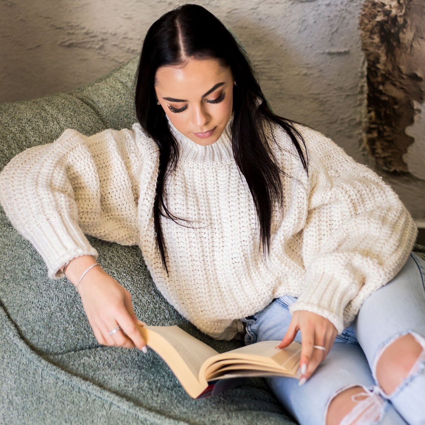 Woman Reading a book on a daybed chair