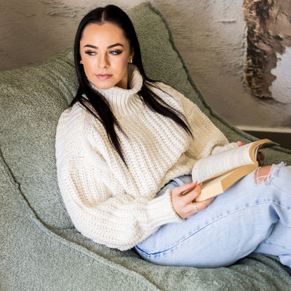 Woman reading on a boucle daybed chair