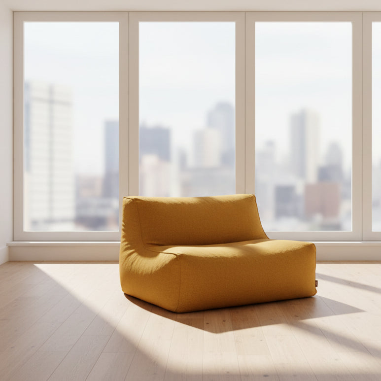 a yellow bean bag chair against a purple wall.